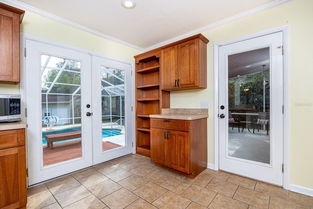 doorway with crown molding and french doors