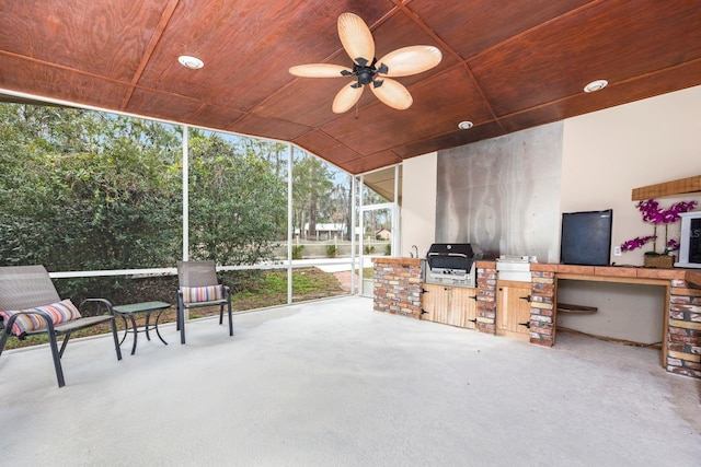 view of patio / terrace with an outdoor kitchen, area for grilling, and ceiling fan