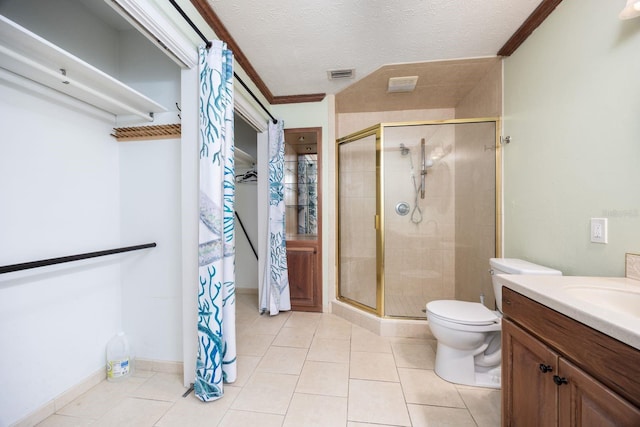 bathroom with vanity, an enclosed shower, toilet, tile patterned floors, and a textured ceiling