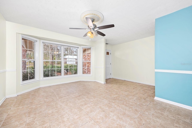 unfurnished room featuring ceiling fan