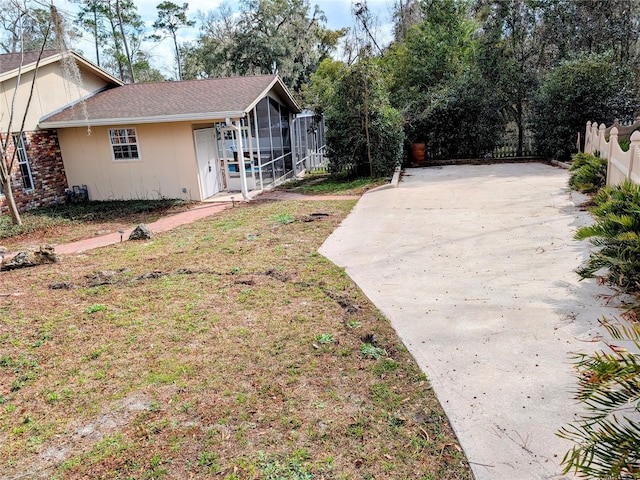 view of yard featuring a sunroom