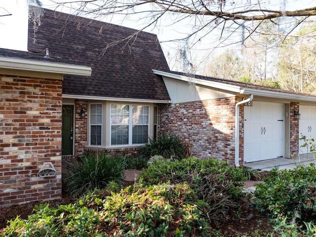 view of exterior entry with a garage