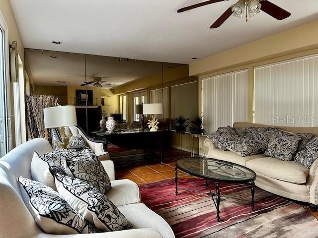 tiled living room with ceiling fan