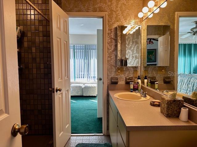 bathroom featuring tile patterned flooring and vanity