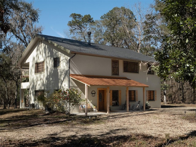 back of house with a patio