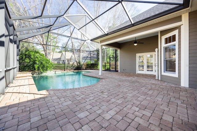 view of swimming pool with french doors, glass enclosure, ceiling fan, and a patio area