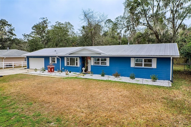 ranch-style house with a garage and a front lawn