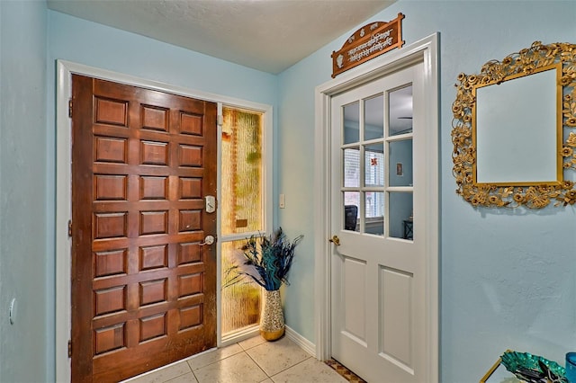 foyer entrance with light tile patterned floors