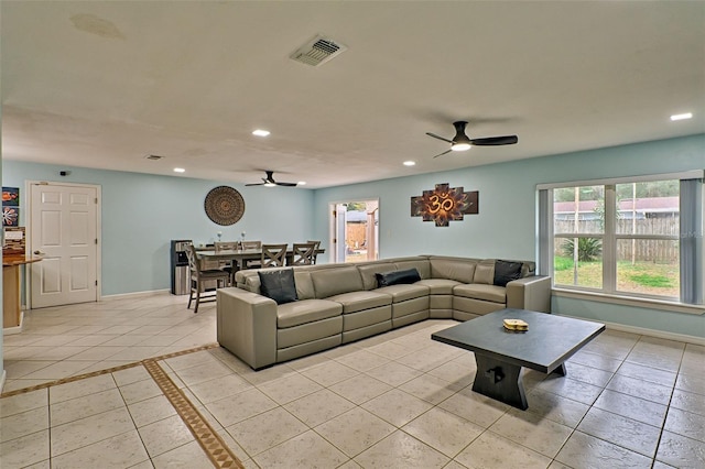 living room with light tile patterned floors and ceiling fan