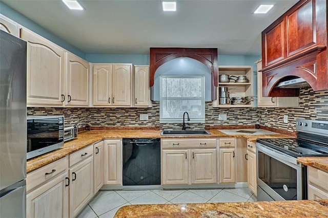 kitchen with tasteful backsplash, appliances with stainless steel finishes, sink, and light tile patterned floors