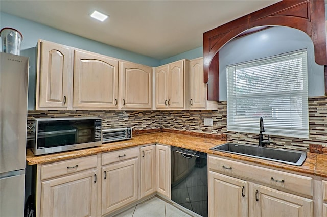 kitchen featuring light tile patterned flooring, appliances with stainless steel finishes, sink, backsplash, and light brown cabinets