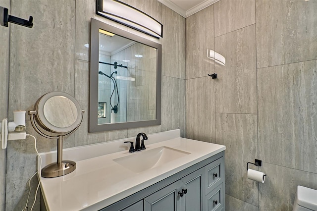 bathroom featuring toilet, a shower with shower door, tile walls, ornamental molding, and vanity