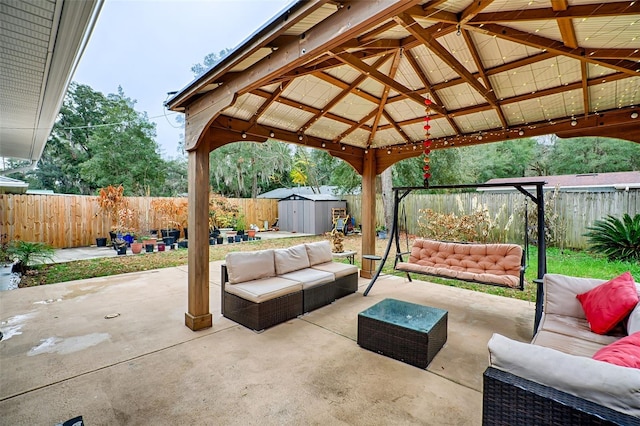 view of patio / terrace featuring an outdoor living space, a gazebo, and a storage unit