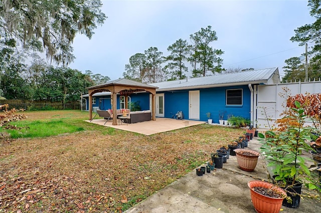 rear view of property with a gazebo, a yard, outdoor lounge area, and a patio area