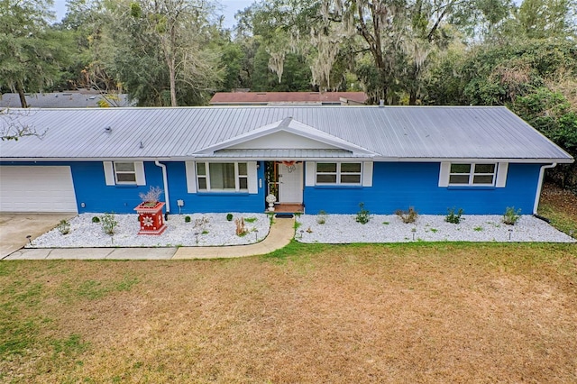 ranch-style home with a garage and a front yard