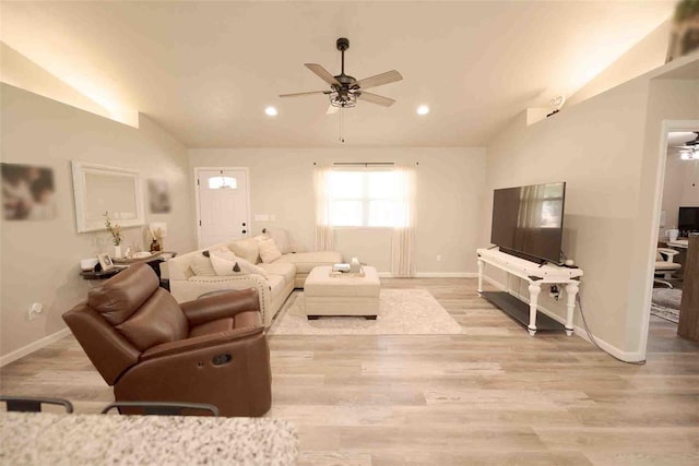 living room featuring lofted ceiling, ceiling fan, and light hardwood / wood-style flooring