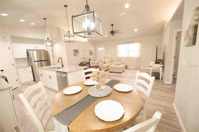 dining area featuring ceiling fan, sink, and light hardwood / wood-style floors