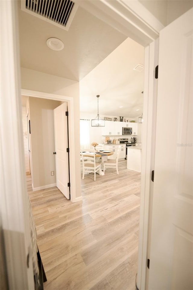 corridor featuring light wood-type flooring