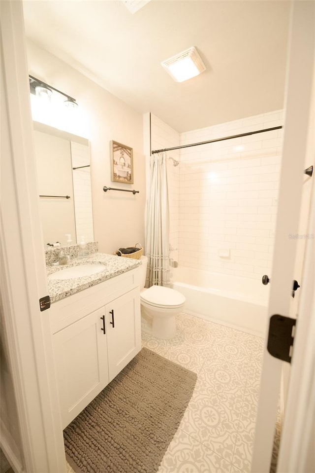 full bathroom with vanity, shower / tub combo with curtain, tile patterned floors, and toilet