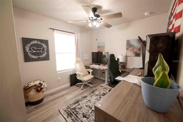 office with ceiling fan and light hardwood / wood-style floors