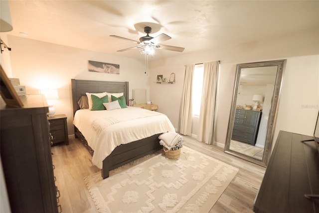 bedroom with ceiling fan and light hardwood / wood-style floors