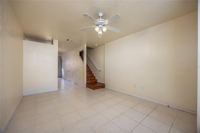 tiled empty room with ceiling fan