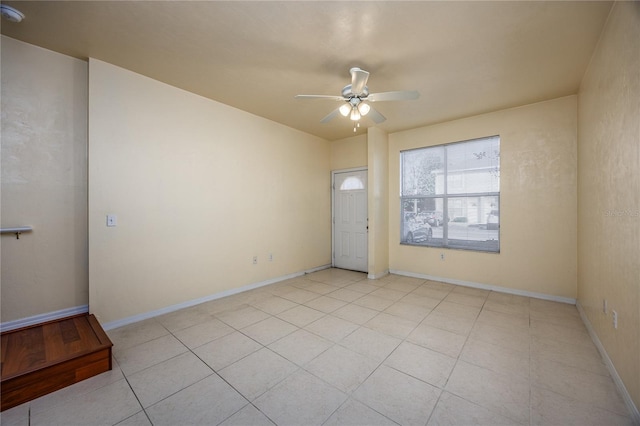 unfurnished room featuring ceiling fan and light tile patterned floors