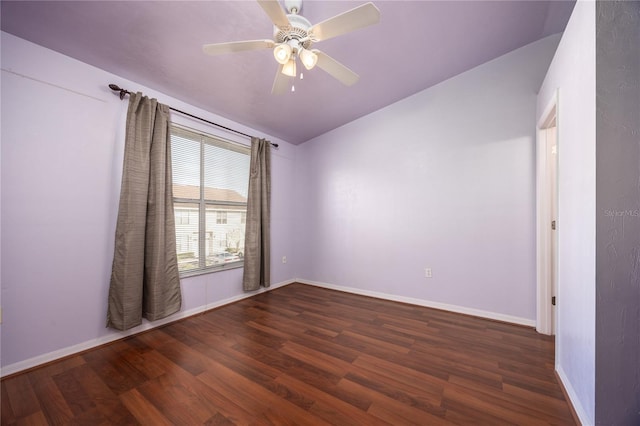 empty room with dark hardwood / wood-style floors and ceiling fan