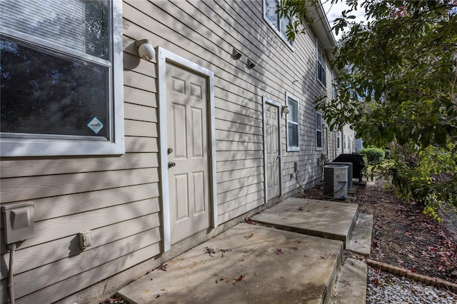 entrance to property with a patio and central AC