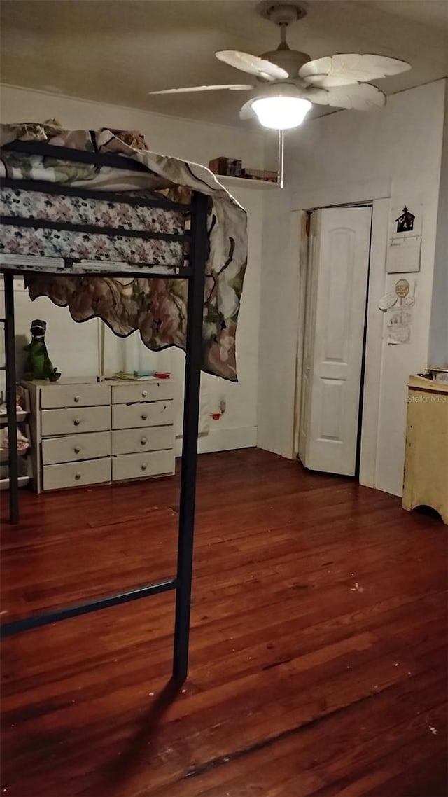 unfurnished bedroom featuring dark hardwood / wood-style floors and ceiling fan