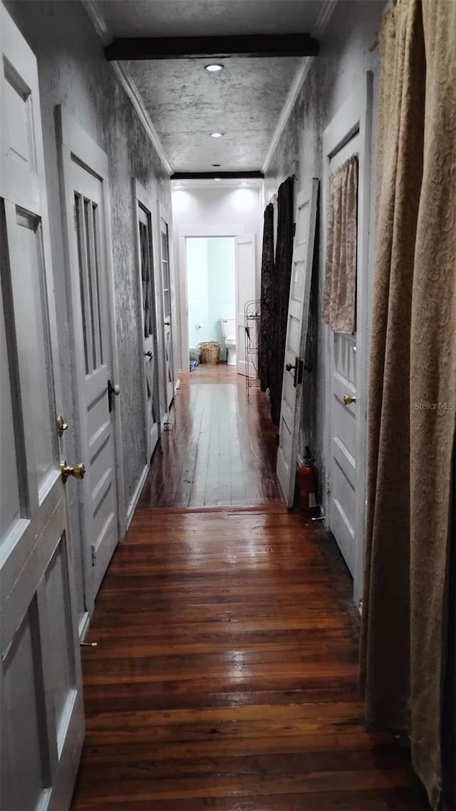 hall with crown molding and dark wood-type flooring