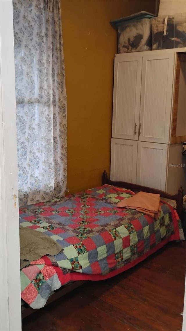 bedroom featuring dark hardwood / wood-style flooring