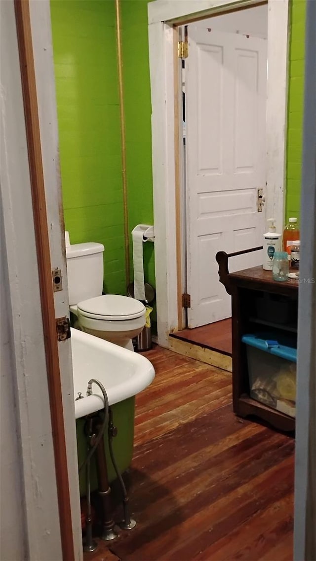 bathroom featuring wood-type flooring and a tub