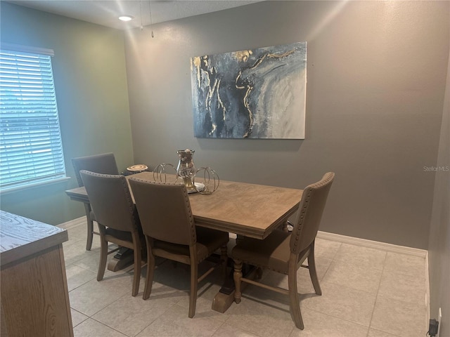 dining area featuring light tile patterned floors and a wealth of natural light