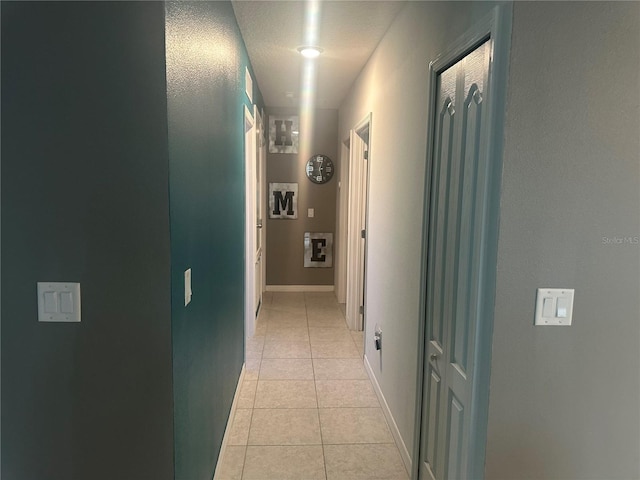 hallway featuring light tile patterned floors