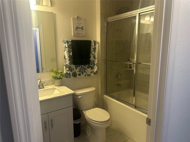 full bathroom with vanity, tile patterned floors, enclosed tub / shower combo, and toilet