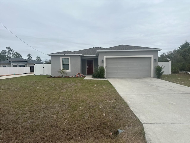 view of front of home featuring a garage and a front lawn