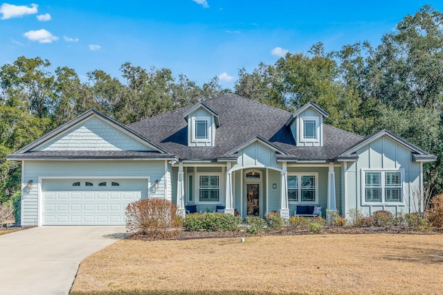 view of front of property featuring a garage and a front lawn