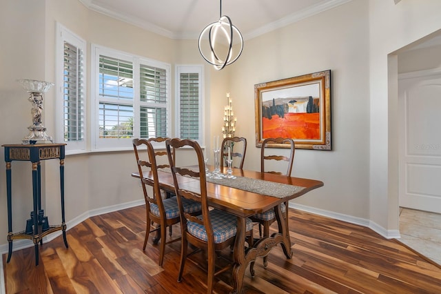 dining area featuring dark hardwood / wood-style flooring and ornamental molding