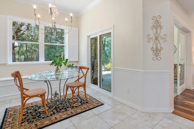 dining room with a notable chandelier and crown molding