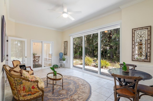 sitting room with ornamental molding, ceiling fan, and light tile patterned flooring