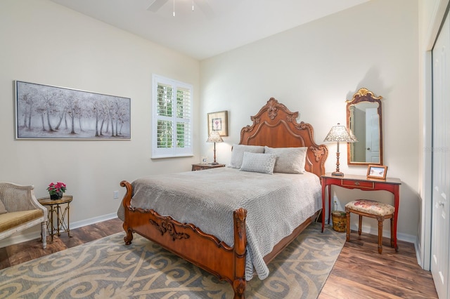 bedroom with a closet, dark hardwood / wood-style floors, and ceiling fan