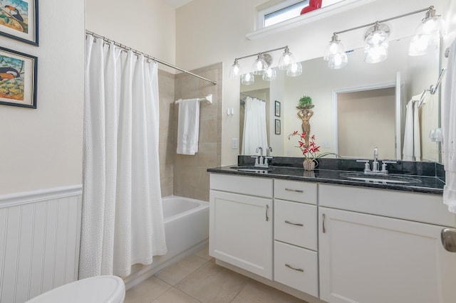 full bathroom featuring tile patterned floors, toilet, vanity, and shower / bath combo