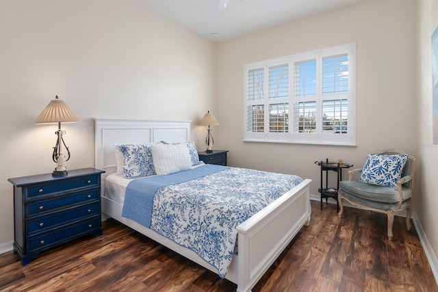 bedroom with dark hardwood / wood-style floors