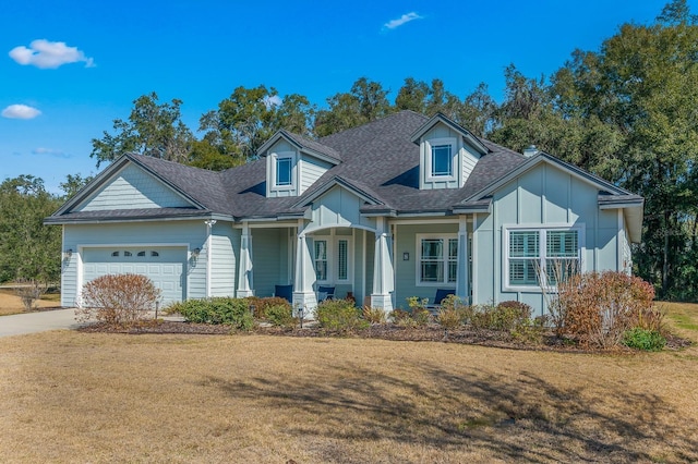 view of front of home featuring a garage, a porch, and a front lawn