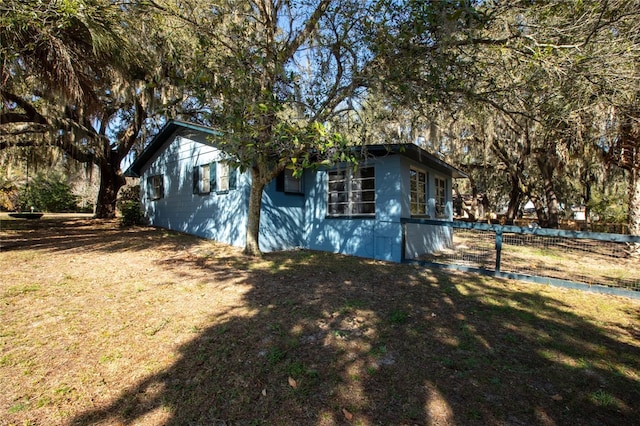 view of home's exterior with a yard