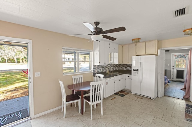 kitchen with white fridge with ice dispenser, sink, ceiling fan, and decorative backsplash