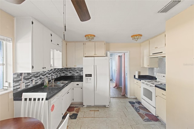 kitchen featuring white appliances, sink, decorative backsplash, and cream cabinetry