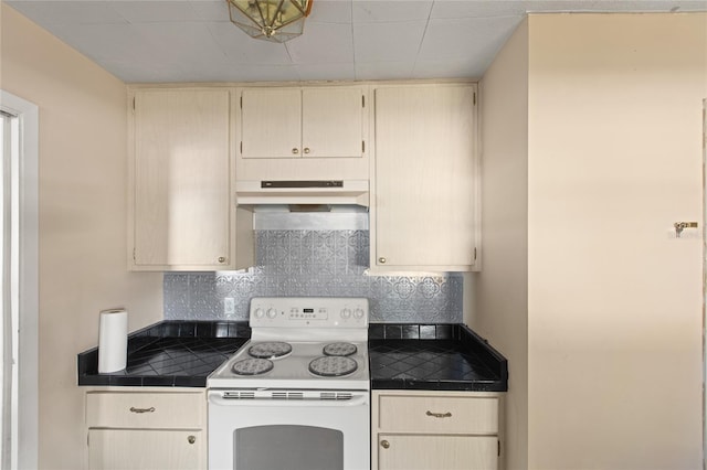 kitchen featuring backsplash, cream cabinets, tile countertops, and white range with electric stovetop