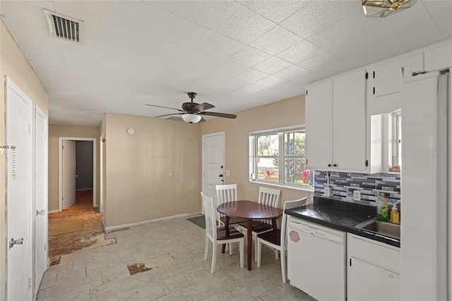 kitchen with tasteful backsplash, white cabinetry, sink, ceiling fan, and white dishwasher